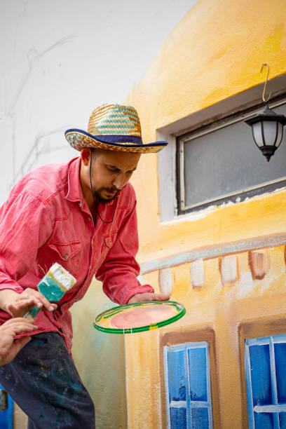 istock Mural painter goes down the ladder, to take a break from the mural painting 1325073228
