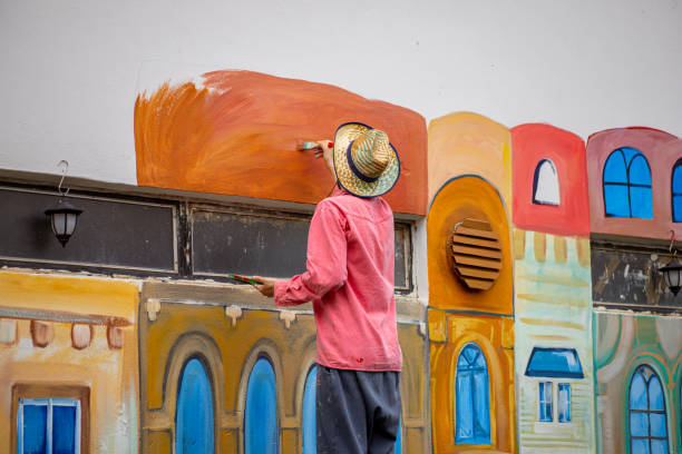 istock Painter using his skill and creativity to refresh the white wall with the colorful mural of small Venice 1325073306