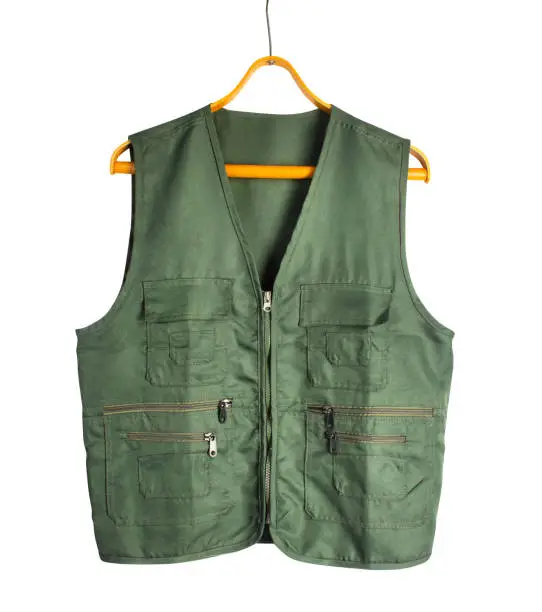 Photo of Isolated photo of green khaki hunting sleeveless jacket on hanger.