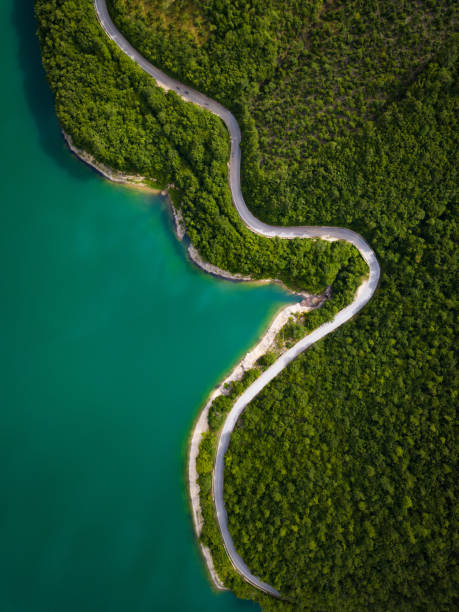 Aerial view of scenic mountain road and lake Aerial view of scenic mountain road and lakeLake Turano in Italy land of lakes stock pictures, royalty-free photos & images