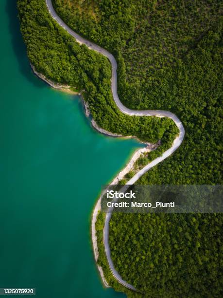 Aerial View Of Scenic Mountain Road And Lake Stock Photo - Download Image Now - Road, Forest, Aerial View