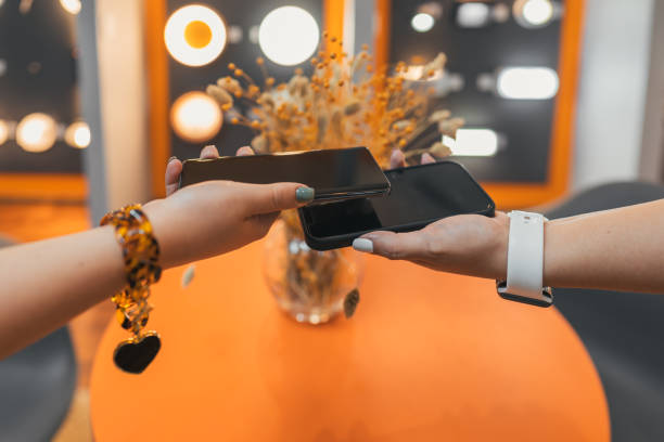 istock Mobile Payment Concept. Money transfer between two smart phones NFC Payment 1325076755