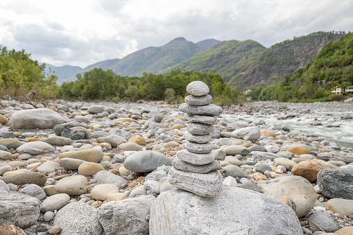Stacking rocks by the river in Switzerland, Ticino canton