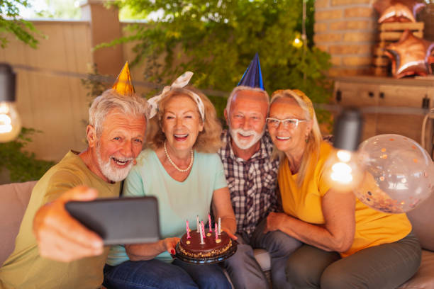 istock Elderly people taking a selfie at a birthday party 1325077204
