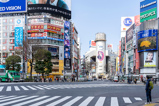 Gifu, Japan - March 22, 2019: View of famous Shibuya pedestrian crossing in Tokyo, Japan. The crossing stops vehicles in all directions to allow pedestrians to inundate the entire intersection.