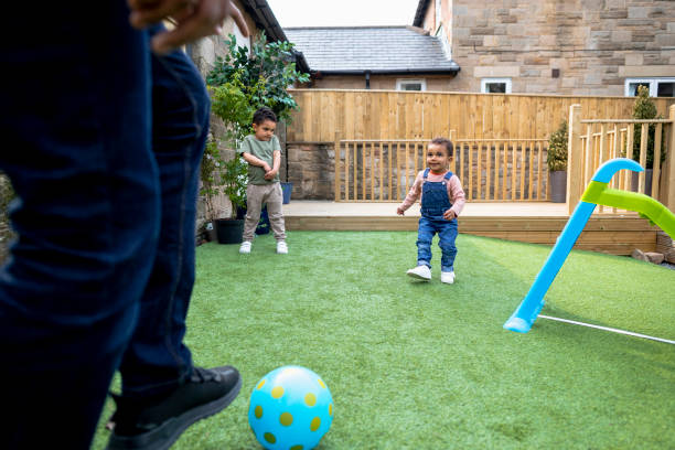 istock Father & Sons Playing Football 1325080488