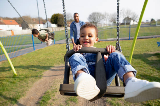 istock Fun on the Swings in the Park 1325080699