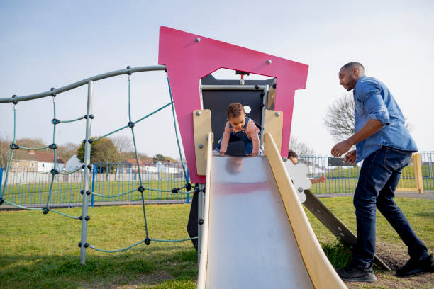 istock Helping My Son up the Jungle Gym 1325080701