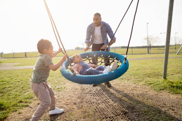 istock Fun on the Swing in the Park 1325080729