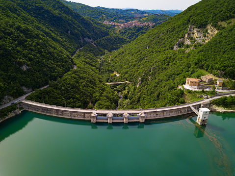 Aerial view of bridge on large dam in italian apennines\nLake Turano in Italy