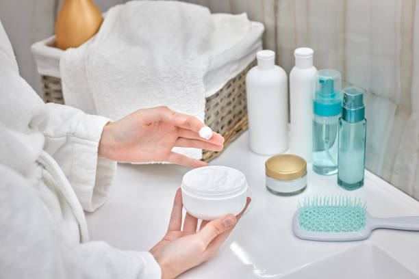 istock female hand holding jar with a cosmetic cream 1325081186
