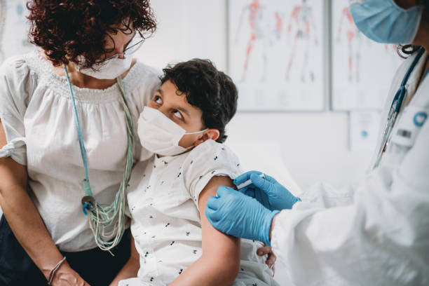 istock A mother is standing by her child while he's getting vaccinated 1325085157