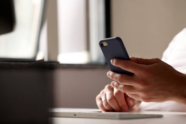 istock Businessman holds a mobile phone or smartphone 1325087713
