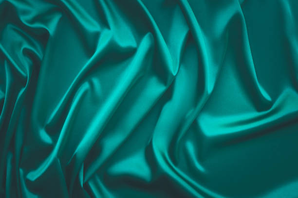 istock Elegant soft abstract green background. Delicate silk waved fabric with copy space for design projects 1325087746