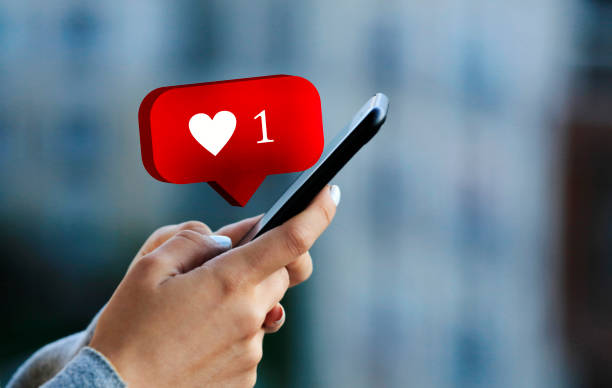 istock Women using mobile phone with heart shape 1325087758