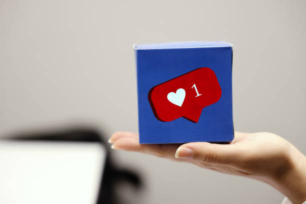 istock woman holding a box with heart shape 1325087795