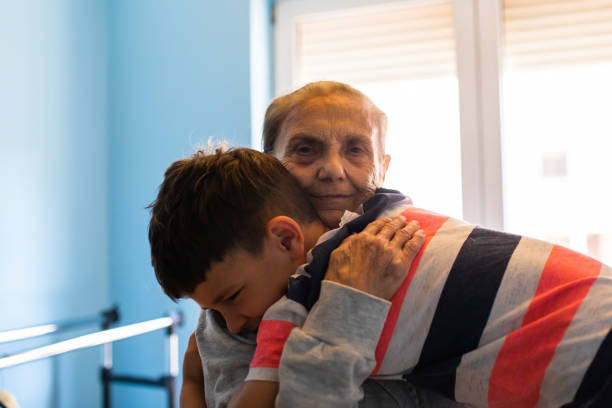 istock An old woman smiling happily while her great grandson is hugging her 1325091496