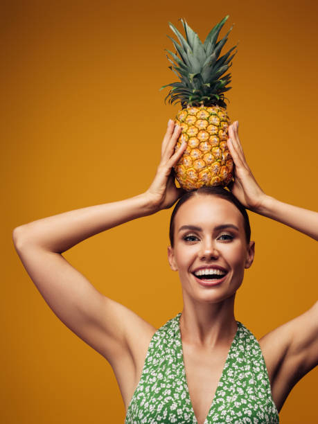 istock Beautiful girl with pineapple 1325096094