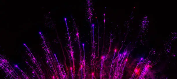 Photo of Fireworks Fourth of July USA Glitter Light Sparks Confetti Dust Particle Exploding Spray Red Blue Purple Magenta Ultra Violet Black Background Fountain In a Row Blurred Motion Copy Space
