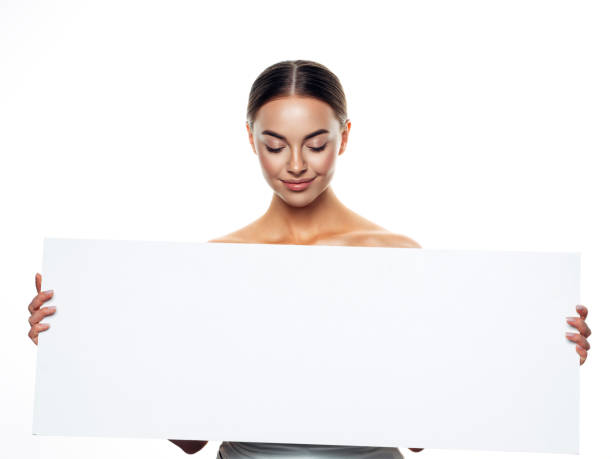 istock Beautiful women with natural make-up holding white placard 1325096649