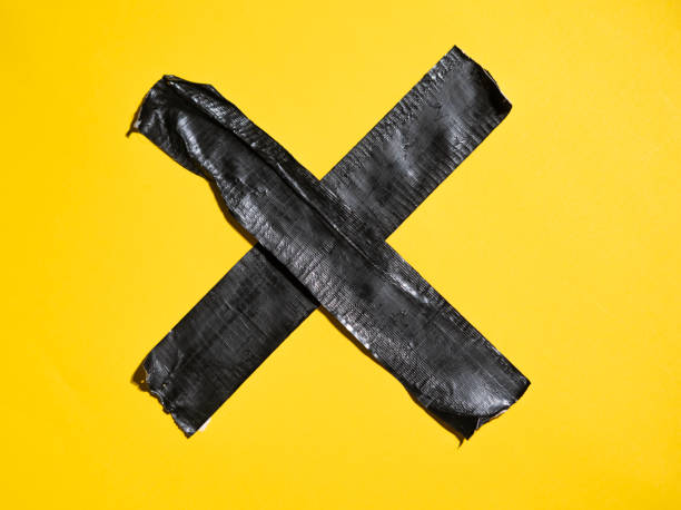 istock black tape on yellow background 1325097538