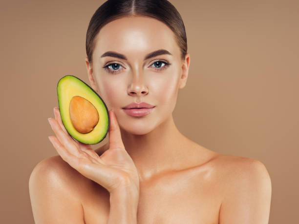 istock Beautiful girl with avocado 1325097757