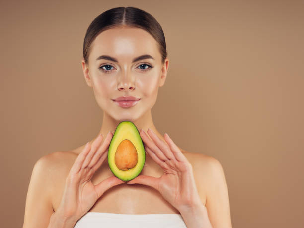 istock Beautiful girl with avocado 1325097788