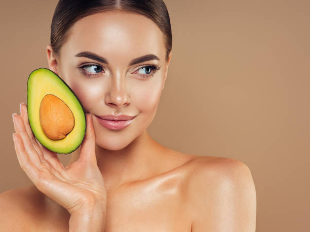 istock Beautiful girl with avocado 1325097837