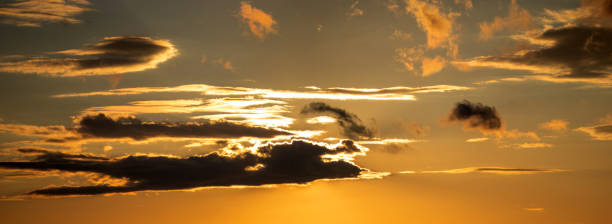 istock The sun shines through the clouds at sunset 1325098112