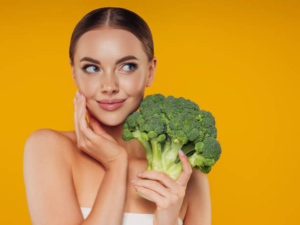 istock Beautiful girl with broccoli 1325099334