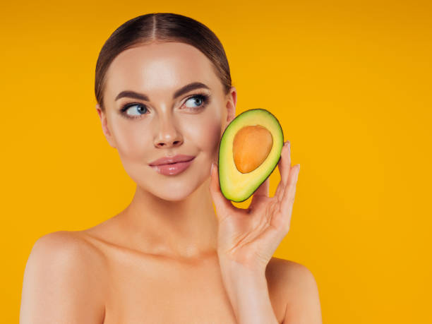 istock Beautiful girl with avocado 1325099372