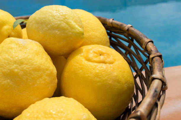 istock yellow lemons in a basket by the pool 1325101020