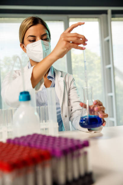 istock Female scientist using a pipette in research laboratory 1325101859