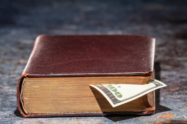 istock One hundred dollar bookmark note in an old book 1325102174
