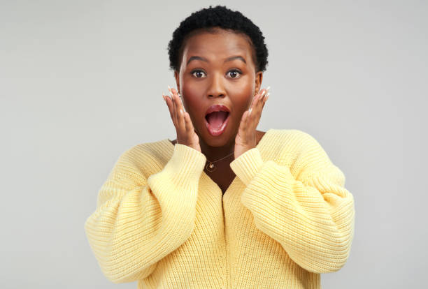 istock Shot of a young woman looking surprised while posing against a grey background 1325102524