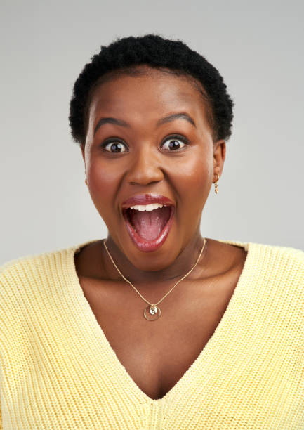 istock Shot of a young woman looking surprised while posing against a grey background 1325102541