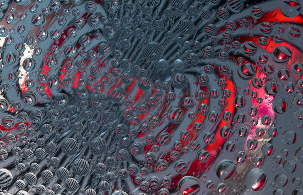 istock Striped spheres rotate in different directions against a graphite-red background. Abstract fantasy. 1325103536
