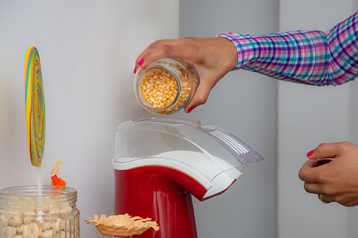 couple making popcorn at home for the June party