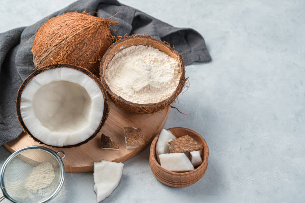 istock Coconut flour, and coconuts on a gray background. Side view, copy space 1325110171