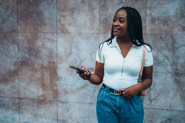 istock Beautiful african american woman using a smartphone 1325110820