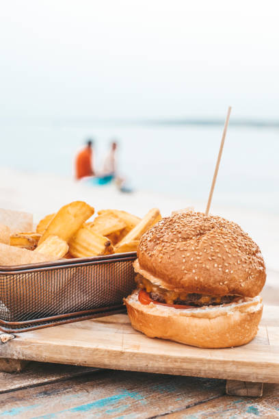 istock Cheeseburger with potatoes in the restaurant on the terrace 1325110832