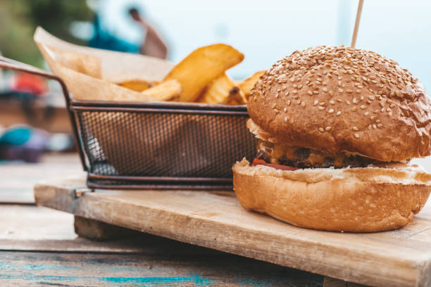 istock Cheeseburger with potatoes in the restaurant on the terrace 1325110874
