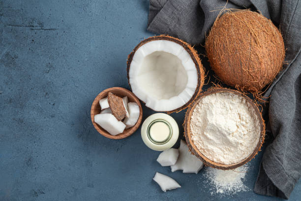 istock Coconut milk, flour and coconuts on a dark background 1325112156