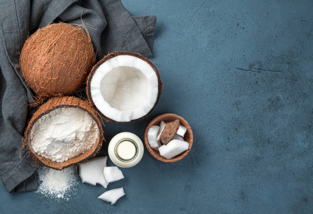 istock Coconut milk, flour and coconuts on a dark background 1325112254