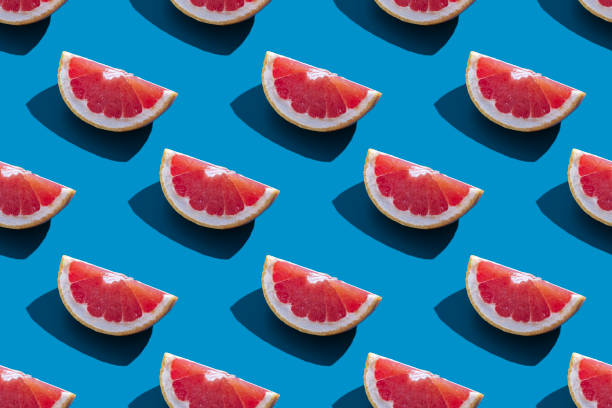 istock Seamless pattern of orange grapefruit with shadow on a blue background. Minimal trendy summer vacation concept. Healthy eating lifestyle. 1325113295