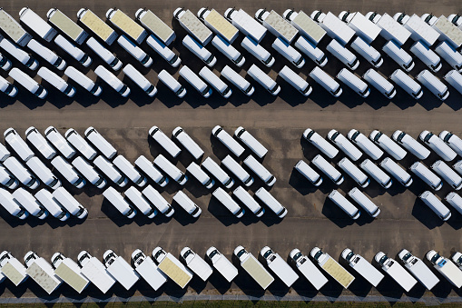 White delivery vans viewed directly from above.