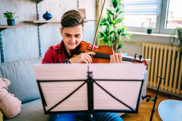 istock Man violinist practicing violin at home 1325116746