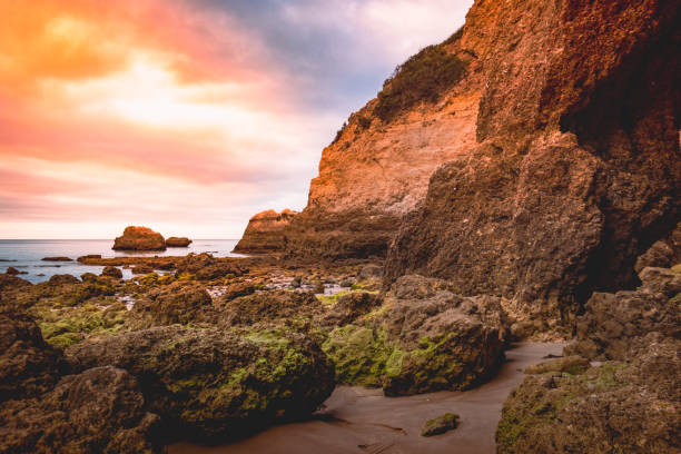 sun through the sea and rocks