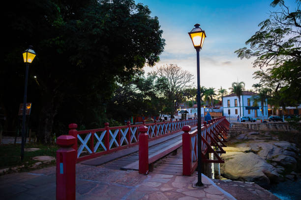 Bridge of Carmo in the city of Pirenopolis. Pirenopolis, Goias, Brazil – June 12, 2021: Bridge of Carmo in the city of Pirenópolis in Goiás over Rio das Almas, made of wood and painted in red and white. Considered one of the city's postcards. goias photos stock pictures, royalty-free photos & images