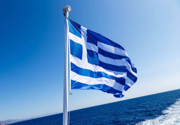 istock Watching the ship wake and the Greek flag 1325120890